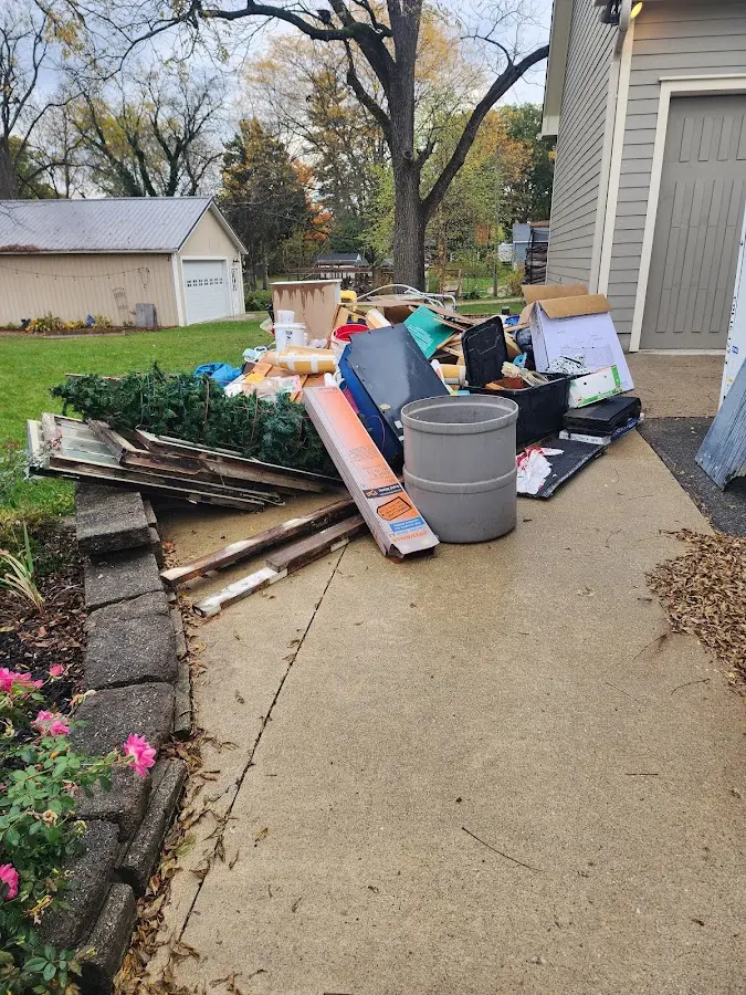 Dumpster being loaded with debris for 12 Yard Dumpster Rental in Forestville